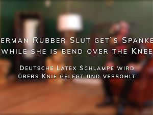 German Rubber Slut Gets Spanked While She Is Bend Over the Knee